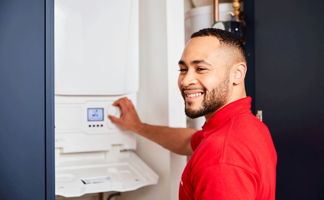 Smiling engineer using boiler control Smiling engineer using boiler control
